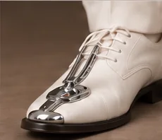 White shoe with a chrome toe ornament